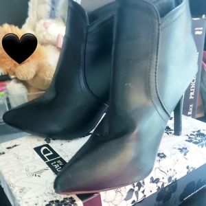 Black closed toe booties/ heels.